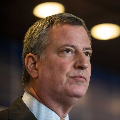 New York City Mayor Bill de Blasio speaks at a press conference after witnessing police being retrained with new guidelines at the Police Academy on December 4, 2014 in the College Point neighborhood of the Queens borough of in New York City. 