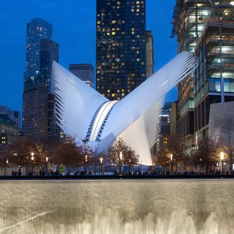 FILE - In this Dec. 11, 2015, file photo, the World Trade Center Transportation Hub, center, overlooks the September 11 Memorial north reflecting pool in New York. When it opens in early March of 2016, the hub will connect visitors to 11 different subway lines, the PATH rail system, Battery Park City Ferry Terminal, the World Trade Center Memorial Site, WTC Towers 1, 2, 3, and 4, the World Financial Center and the Winter Garden. (AP Photo/Mark Lennihan, File)