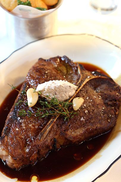 35 Day Prime Porterhouse, topped with cremini mushroom and escargot butter. Pommes soufflés on the side.