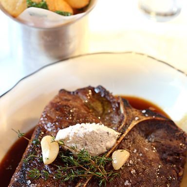 35 Day Prime Porterhouse, topped with cremini mushroom and escargot butter. Pommes soufflés on the side.