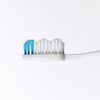 Toothbrush head with blue stripe, close-up