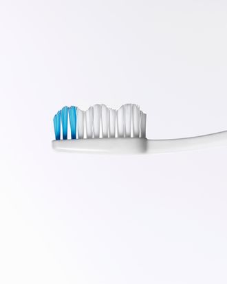 Toothbrush head with blue stripe, close-up