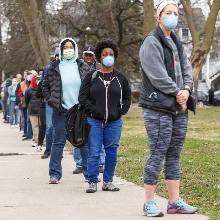 Amid coronavirus pandemic, voters line up in Wisconsin to cast their ballots.