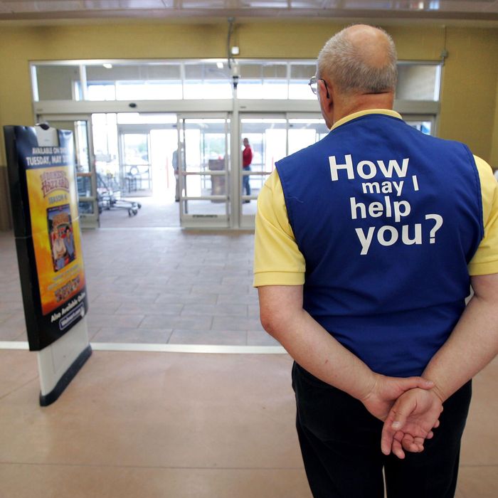 A Wal-Mart greeter waits to welcome new customers to the new 2,000 square foot Wal-Mart Supercenter store May 17, 2006 in Bowling Green, Ohio. The new store, one of three new supercenters opening today in Ohio, employs 340 people with 60 percent of those working full-time.