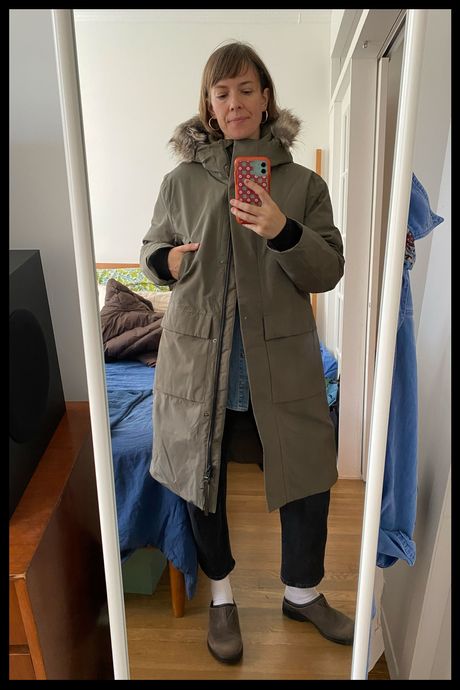 Photo of Strategist senior writer Liza Corsillo wearing the Quince Women's Responsible Down Hooded Long Parka in faded cargo.