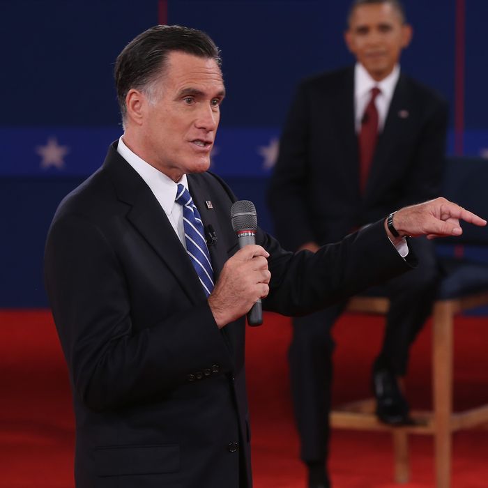 HEMPSTEAD, NY - OCTOBER 16: Republican presidential candidate Mitt Romney (L) speaks as U.S. President Barack Obama listens during a town hall style debate at Hofstra University October 16, 2012 in Hempstead, New York. During the second of three presidential debates, the candidates fielded questions from audience members on a wide variety of issues. (Photo by Spencer Platt/Getty Images)