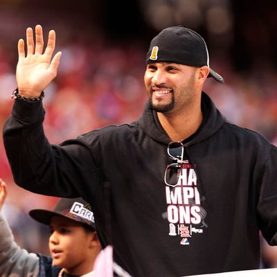 First baseman Albert Pujols of the St. Louis Cardinals waves to the crowd during the World Series victory parade for the franchise's 11th championship on October 30, 2011 in St Louis, Missouri.