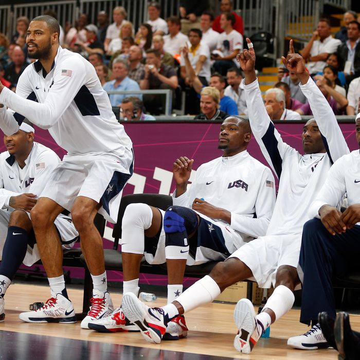 Tyson Chandler #4 and Kobe Bryant #10 of United States cheer on their teammates against France in the Men's Basketball Game on Day 2 of the London 2012 Olympic Games