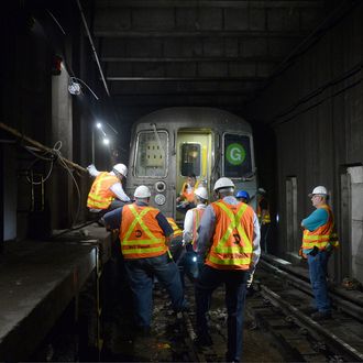 MTA New York City Transit personnel work at the scene of a G train derailment near the Hoyt-Schermerhorn station, as they attempt to restore service late in the evening of Sept. 10, 2015.