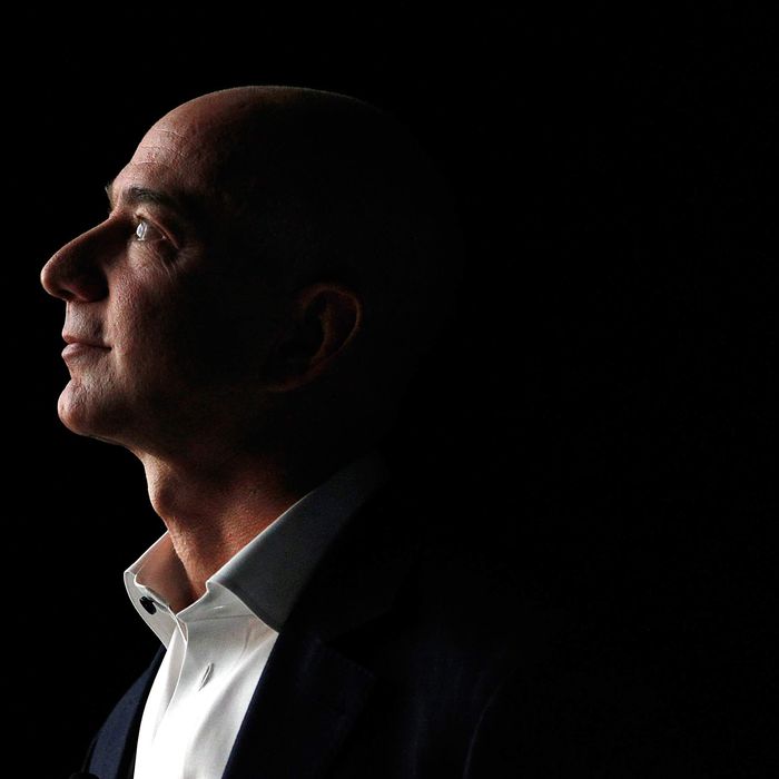 Jeff Bezos, chief executive officer of Amazon.com Inc., watches a video of the new Kindle Fire HD tablet at a news conference in Santa Monica, California, U.S., on Thursday, Sept. 6, 2012. Amazon.com Inc. is updating its line of Kindle e-readers and tablets in a bid to stoke consumer demand as Google Inc. and Microsoft Corp. join the crowded market of machines challenging Apple Inc.'s iPad.