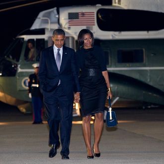 President Barack Obama and first lady Michelle Obama walks from Marine One to board Air Force One at John F. Kennedy International Airport, Friday, June 15, 2012, in Andrews Air Force Base, Md., en route Washington.