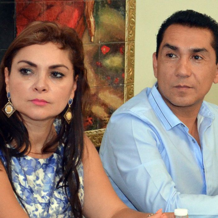 In this May 8, 2014 file photo, the mayor of the city of Iguala, Jose Luis Abarca, right, and his wife Maria de los Angeles Pineda Villa meet with state government officials in Chilpancingo, Mexico. Abarca ordered a police attack that resulted in six deaths and the disappearance of 43 students who remain missing weeks later, the country's top prosecutor, Murillo Karam, said Wednesday, Oct. 22. Karam also said Abarca's wife has been linked to drug gangs and is now considered a fugitive, along with her husband and the Iguala police chief. (AP Photo/Alejandrino Gonzalez, File)