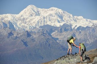 Backpackers hikes Kesugi Ridge Trail in Denali State Park, Alaska.