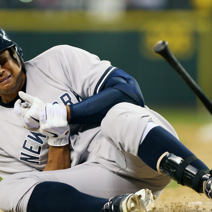 Alex Rodriguez #13 of the New York Yankees crumples to the ground after being hit with a pitch by starting pitcher Felix Hernandez of the Seattle Mariners at Safeco Field on July 24, 2012