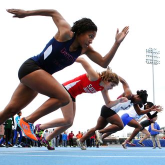 High School athletes at the start of the 100m race during the 2013 NYC Mayor's Cup Outdoor Track and Field Championships at Icahn Stadium on Randall's Island, 13th April 2013.