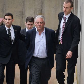 Former Suffolk County Police Chief James Burke is escorted to a vehicle by FBI personnel outside an FBI office in Melville, N.Y. on Wednesday, Dec. 9, 2015. Prosecutors didn't immediately announce charges, but Burke had been under scrutiny for years over an allegation that he beat a prisoner in 2012. He resigned from the force in October. (Steve Pfost/Newsday via AP) NYC LOCALS OUT; MANDATORY CREDIT Newsday photo by Steve Pfost