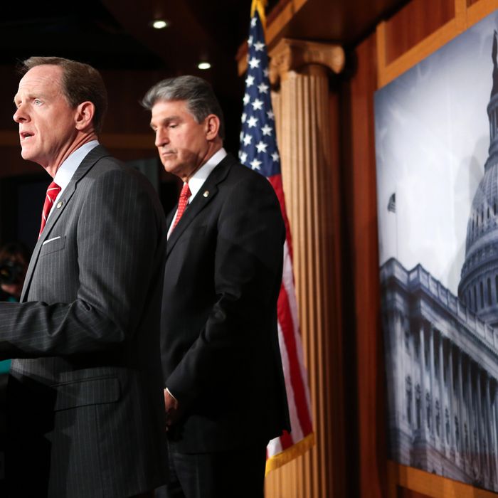 Sen. Pat Toomey (R-PA) (L) and Sen. Joe Manchin (D-WV) speak to the press about background checks for gun purchases, in the U.S. Capitol building April 10, 2013 in Washington DC. The pair is proposing a bipartisan compromise, a proposal to be voted on as an amendment that would expand background checks to firearms sales at gun shows and on the Internet.