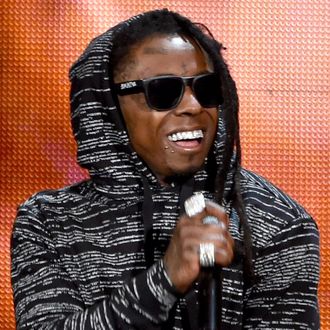 Recording artist Lil Wayne performs onstage at the 2014 American Music Awards at Nokia Theatre L.A. Live on November 23, 2014 in Los Angeles, California. (Photo by Kevin Winter/Getty Images)