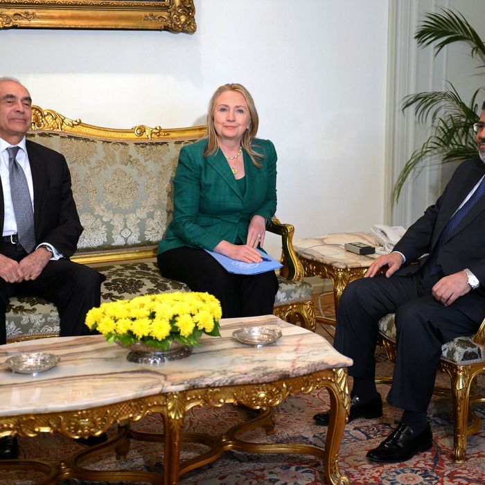Egyptian President Mohamed Morsi (R) and his Foreign Minister Mohammed Kamel Amr (L) meet with US Secretary Hilary Clinton at the presidential palace in Cairo on November 21, 2012. Clinton's visit comes amid a flurry of diplomatic activity aimed an bringing an end to the conflict which has killed over 130 people in a week.