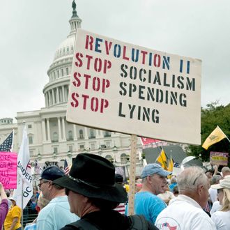 A demonstrator carries a sign calling for a second American revolution to bring an end to alleged Socialism, spending and lying in front of the US Capitol during a march by supporters of the conservative Tea Party movement in Washington on September 12, 2010.