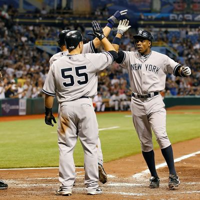 Outfielder Curtis Granderson #14 of the New York Yankees is congratulated by Derek Jeter #2 and Russell Martin #55 after this fifth inning three run home run against the Tampa Bay Rays during the game at Tropicana Field on May 16, 2011 in St. Petersburg, Florida.