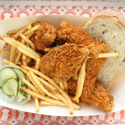 Fried-chicken combo dinners come with rosemary bread, pickled cucumbers, and fries.