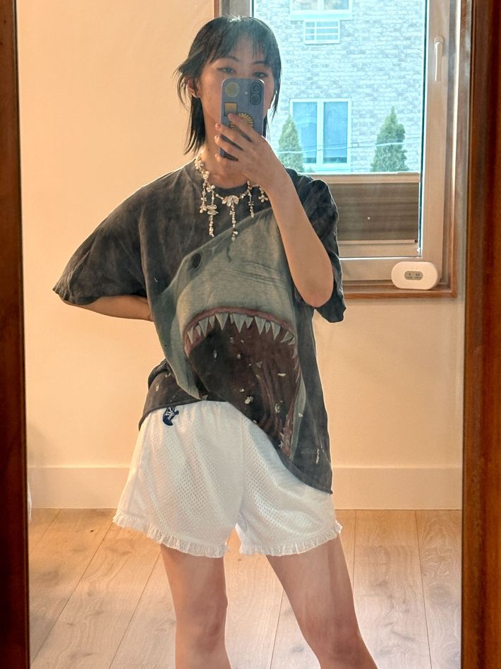 Selfie of the author wearing the Relax Lacrosse x Beditorial shorts, which are white with ruffles.