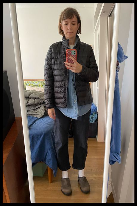 Photo of Strategist senior writer Liza Corsillo wearing the Quince Women's Lightweight Down Packable Puffer in black.