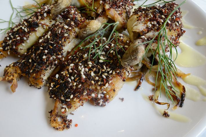 Confited chicken wings, topped with seeds and spices and garnished with caramelized fennel and fronds.