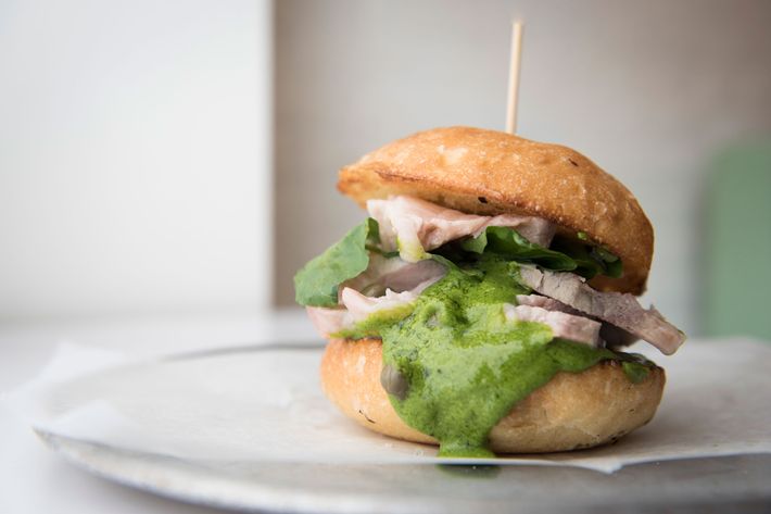 Porchetta-spiced-pork-shoulder sandwich with salsa verde.