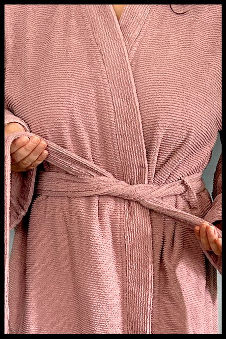 Brooklinen's Organic Ribbed Robe on the writer of this bathrobe guide, zoomed in to show the waist tie and the stripy texture of the fabric.