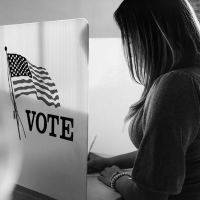 Woman voting at polling station.
