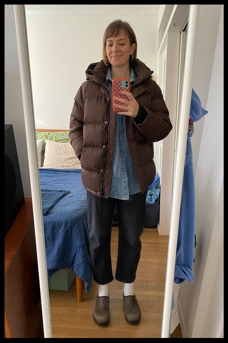 Photo of Strategist senior writer Liza Corsillo wearing the Quince Women's Responsible Down Puffer in chocolate brown.