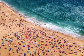 Aerial View Of Tourists On Beach