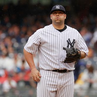 Joba Chamberlain #62 of the New York Yankees reacts to the action in the seventh-inning against the Baltimore Orioles at Yankee Stadium on August 1, 2012 in the Bronx borough of New York City. 