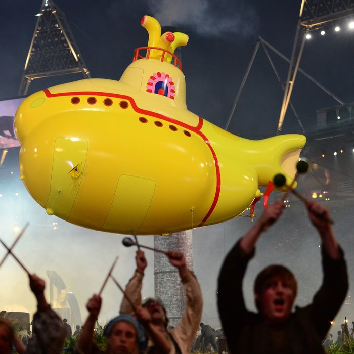 An inflatable yellow submarine floats above artists performing during the opening ceremony of the London 2012 Olympic Games on July 27, 2012 at the Olympic stadium in London. 