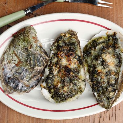 Broiled oysters with sea lettuce, spring onion, and Parmesan.