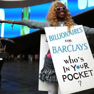 NEW YORK, NY - SEPTEMBER 28: A protester stands in front of the new Barclays Center on opening night, which was to feature recording artist Jay-Z on September 28, 2012 in the Brooklyn borough of New York City. Dozens of protesters and curious onlookers converged on the new arena which caused debate and controversy when it was originally proposed nine years ago. The $1 billion arena will bring a professional sports team, the Brooklyn Nets, back to Brooklyn for the first time in more than a half-century. (Photo by Spencer Platt/Getty Images)