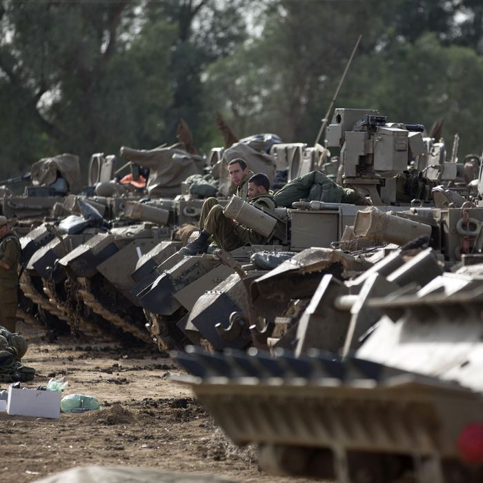 Israeli soldiers sit atop their armoured personnel carriers (APC) stationed on Israel's border with the Gaza Strip on November 16, 2012. Israeli officials said the Jewish state was preparing to launch its first ground offensive in four years into the Gaza Strip and the army started calling up reservists.