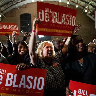 NEW YORK, NY - NOVEMBER 05: Lori Zeno (C), a supporter of newly elected New York City Mayor Bill de Blasio, waves a sign while waiting for de Blasio to walk out at his election night party on November 5, 2013 in New York City. De Blasio beat out Republican candidate Joe Lhota and will succeed Michael Bloomberg as the 109th mayor of New York City. He is the first Democratic mayor in 20 years. (Photo by Andrew Burton/Getty Images)