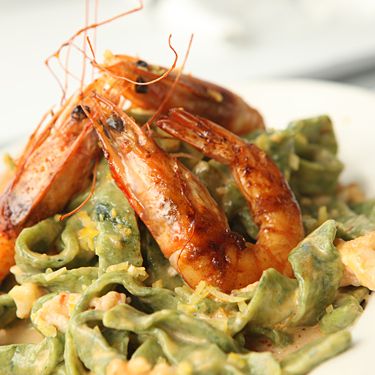 Homemade fresh pasta in a light lemon cream sauce with caramelized shrimp.