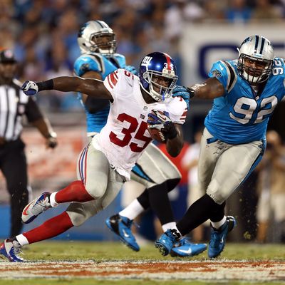 Andre Brown #35 of the New York Giants runs the ball in the first half against Gary Barnidge #82 of the Carolina Panthers at Bank of America Stadium on September 20, 2012 in Charlotte, North Carolina.