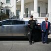 Elon Musk and Donald Trump stand in front of a Tesla Cybertruck