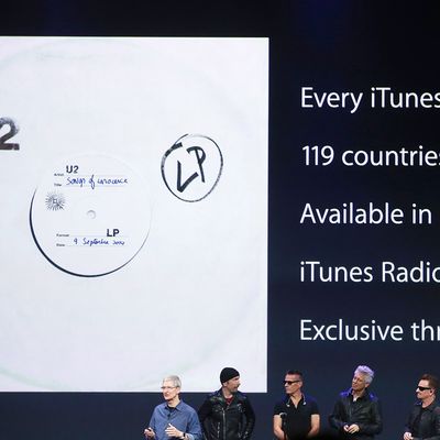 CUPERTINO, CA - SEPTEMBER 09: Apple CEO Tim Cook (L) announces the free download of the new U2 album on iTunes as members of U2 The Edge (2nd L), Larry Mullen Jr (C), Adam Clayton (2nd R) and Bono as and look on during an Apple special event at the Flint Center for the Performing Arts on September 9, 2014 in Cupertino, California. Apple unveiled the Apple Watch wearable tech and two new iPhones, the iPhone 6 and iPhone 6 Plus. (Photo by Justin Sullivan/Getty Images)