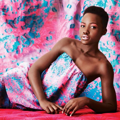 Lupita Nyong'o against an abstract pink and blue backdrop — the Strategist reviews the best concealers for brown and dark skin.