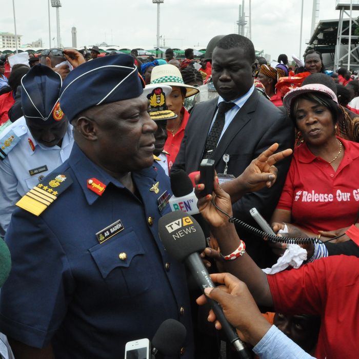 Nigeria's chief of defense staff Air Marshal Alex S. Badeh, centre, speaks during a demonstration calling on the government to rescue the kidnapped girls of the government secondary school in Chibok, in Abuja, Nigeria, Monday, May 26, 2014. Scores of protesters chanting