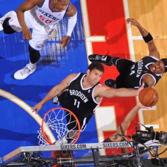 Brook Lopez #11 of the Brooklyn Nets grabs a rebound against the Philadelphia 76ers at the Wells Fargo Center on December 20, 2013 in Philadelphia, Pennsylvania.