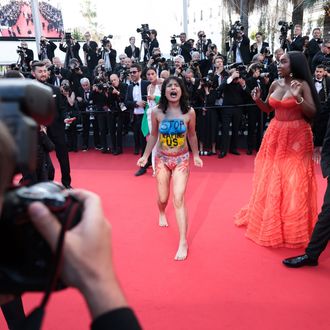 Topless, screaming woman crashes Cannes red carpet to protest war