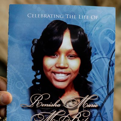  A mourner holds an obituary showing a picture of 19-year-old shooting victim Renisha McBride during her funeral service in Detroit, Michigan November 8, 2013. McBride was shot dead on November 2 at a home where she sought help after a car accident in Dearborn Heights, Michigan. 