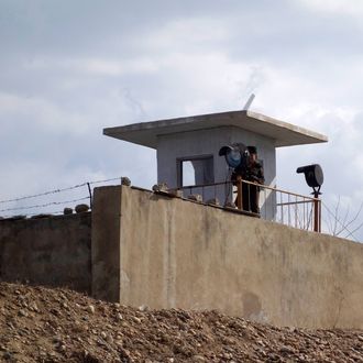 A North Korean soldier stands guard on the banks of the Yalu River at the North Korean town of Sinuiju across from the Chinese city of Dandong, in northeastern Liaoning province on April 10,2013. 